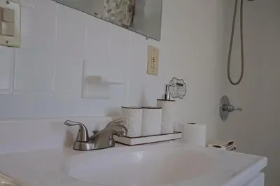 a bathroom sink with two rolls of toilet paper on it at Cozy Home, 19m to NYC, 10m to American Dream in Wallington