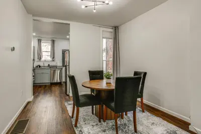 a dining room with a table and chairs at 3-Story Rowhouse with Patio! 5 Mi to Center City in Philadelphia