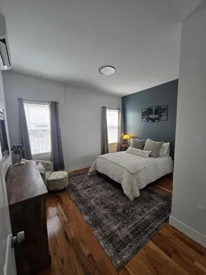 a bedroom with a bed and a rug at The Harrison in Harrison