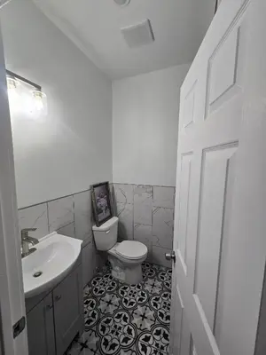 a white bathroom with a sink and a toilet at The Harrison in Harrison