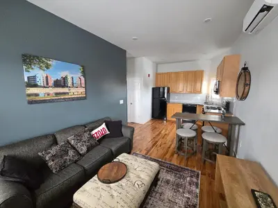 a living room with a couch and a kitchen at The Harrison in Harrison