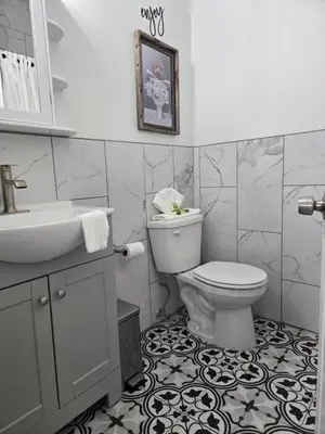 a bathroom with a toilet and a sink at The Harrison in Harrison