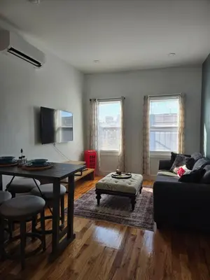 a living room with a table and a couch at The Harrison in Harrison