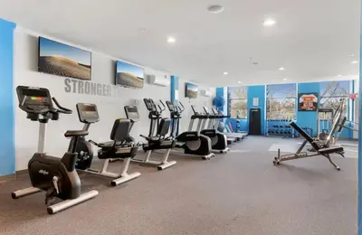 a gym with several treadmills and cardio machines at Luxury Studio Loft - Rooftop View & Pool in Philadelphia