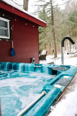 a swimming pool in the snow next to a house at Hot Tub, Wood-burning Fireplace and 4 acres of Forest in Margaretville in Margaretville