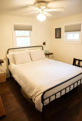 a bed in a bedroom with a ceiling fan at Hot Tub, Wood-burning Fireplace and 4 acres of Forest in Margaretville in Margaretville