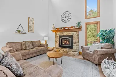 a living room with a couch and a fireplace at Pine Hollow Lodge in Duncannon