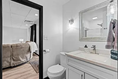 a white bathroom with a toilet and a sink at Pine Hollow Lodge in Duncannon