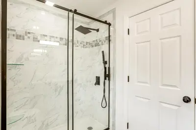 a shower with a glass door in a bathroom at Walk to River, Parks and Dining Family Home with Yard