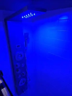 a bathroom with blue lights on the wall and toilets at Entire Spacious House in New Jersey in East Orange