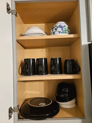 a cupboard filled with pots and pans at Entire Spacious House in New Jersey in East Orange