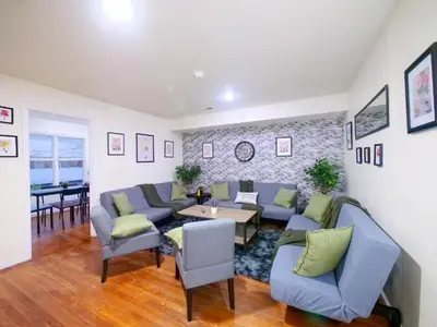 a living room with blue couches and a table at Bright Private Room with Shared Bathroom near NYC in Jersey City