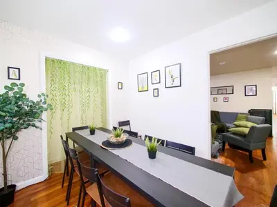 a living room with a table and chairs and a couch at Bright Private Room with Shared Bathroom near NYC in Jersey City