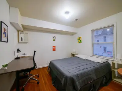 a bedroom with a bed and a desk and a desk at Cozy Private Room with Shared Kitchen near NYC in Jersey City