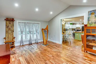 a living room with a wooden floor and a kitchen at Serene Getaway with Trail Access in Chester Springs in Chester Springs
