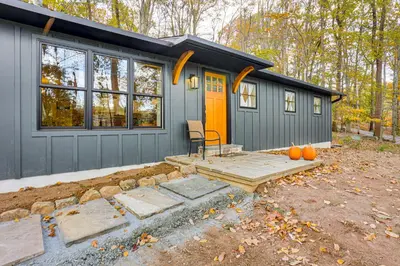 a tiny house with an orange door in a yard at Serene Getaway with Trail Access in Chester Springs in Chester Springs