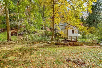 a house in the middle of a yard with trees at Serene Getaway with Trail Access in Chester Springs in Chester Springs