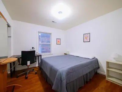 a bedroom with a bed and a desk and a computer at Mins to NYC Comfy Private Room in Shared Home in Jersey City