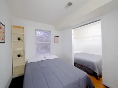 a bedroom with two beds and a window at Charming Room with Shared Space close to NYC in Jersey City