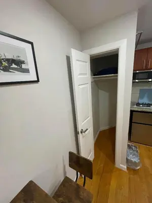 a room with a door and a chair and a kitchen at Union Square Studio with Kitchen -Shared Bathroom in New York