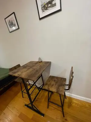 a wooden table and a bench and a table and chair at Union Square Studio with Kitchen -Shared Bathroom in New York