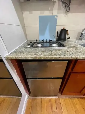 a kitchen counter with a sink and a stove at Union Square Studio with Kitchen -Shared Bathroom in New York
