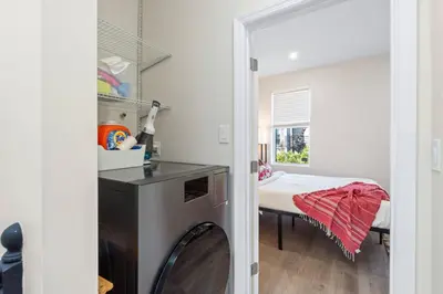 a kitchen with a washing machine in a room at Elegant Home w Patio | In-Unit Laundry Near NYC in Jersey City