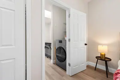 a laundry room with a washer and dryer at Elegant Home w Patio | In-Unit Laundry Near NYC in Jersey City