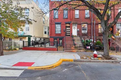 a fire hydrant on a street in front of buildings at Elegant Home w Patio | In-Unit Laundry Near NYC in Jersey City