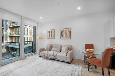 a living room with a couch and a table at Luxury 1BR Getaway - Modern Stylish & Great Area in Philadelphia