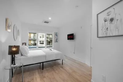 a white room with a bed and a window at Luxury 1BR Getaway - Modern Stylish & Great Area in Philadelphia