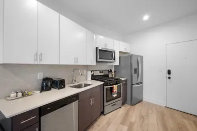 a kitchen with white cabinets and stainless steel appliances at Luxury 1BR Getaway - Modern Stylish & Great Area in Philadelphia