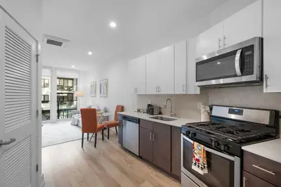 a kitchen with white cabinets and a stove top oven at Luxury 1BR Getaway - Modern Stylish & Great Area in Philadelphia