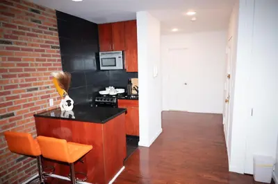 a kitchen with a counter and a stove top oven at West Village Escape - Steps from Subway Cafes in New York