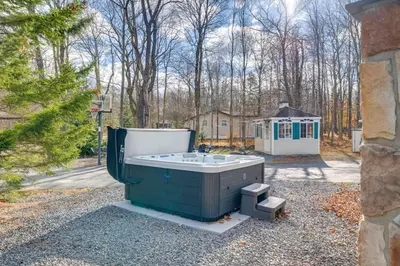 a bath tub sitting in a yard with a house at Game Room, Hot Tub and Fire Pit Pocono Lake Escape! in Pocono Lake