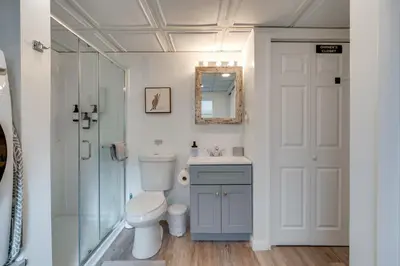 a bathroom with a toilet and a sink and a shower at Game Room, Hot Tub and Fire Pit Pocono Lake Escape! in Pocono Lake