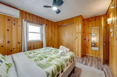 a bedroom with a bed and a ceiling fan at Game Room, Hot Tub and Fire Pit Pocono Lake Escape! in Pocono Lake