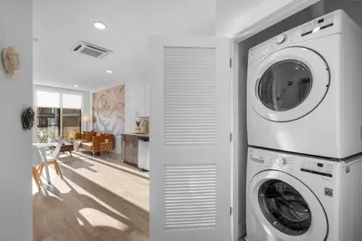a white laundry room with a washer and dryer at Premium 1BR - Workstation Pool Balcony in Philadelphia