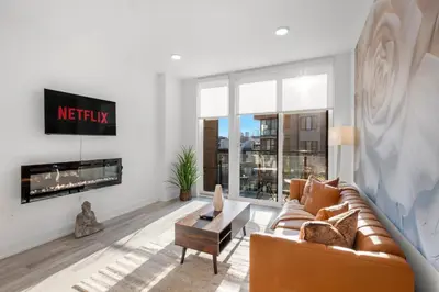 a living room with a couch and a fireplace at Premium 1BR - Workstation Pool Balcony in Philadelphia