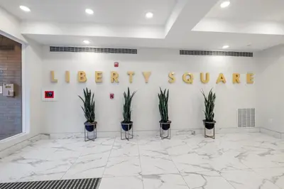 a lobby with a library square sign on the wall at Premium 1BR - Workstation Pool Balcony in Philadelphia