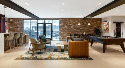 a living room with a pool table and a bar at express housing in Philadelphia