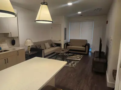 a kitchen and living room with a couch and a table at express housing in Philadelphia