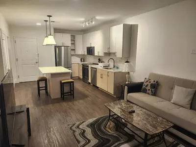 a living room and kitchen with a couch and a table at express housing in Philadelphia