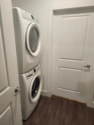 a washer and dryer in a room with a door at express housing in Philadelphia