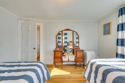 a bedroom with a mirror and a dresser and a bed at All-Season Getaway on Lake Winola Dock and Sunroom! in Factoryville