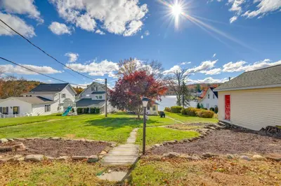 a house in a residential neighborhood with a yard at All-Season Getaway on Lake Winola Dock and Sunroom! in Factoryville