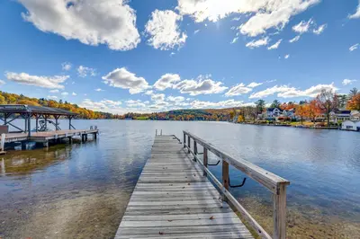 a dock on a lake with a cloudy sky at All-Season Getaway on Lake Winola Dock and Sunroom! in Factoryville