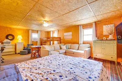 a bedroom with a bed and a living room at Hike, Ski and Golf Water-View Lake Winola Retreat! in Factoryville