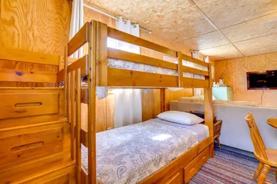 a bedroom with a bunk bed and a desk at Hike, Ski and Golf Water-View Lake Winola Retreat! in Factoryville
