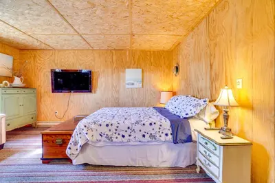 a bedroom with a bed and a tv in it at Hike, Ski and Golf Water-View Lake Winola Retreat! in Factoryville